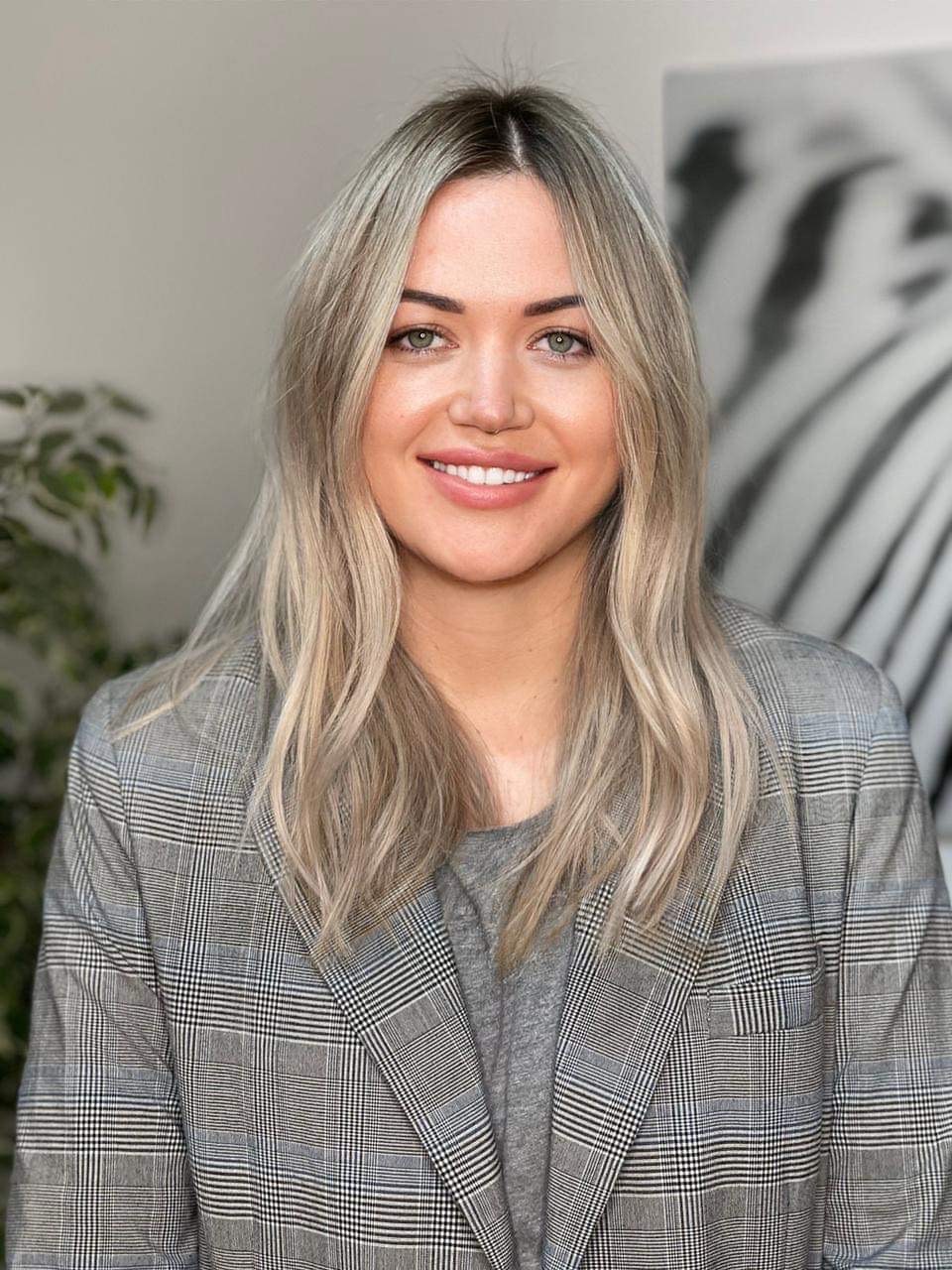 Inga. Smiling light brown hair girl wearing a gray suitjacket