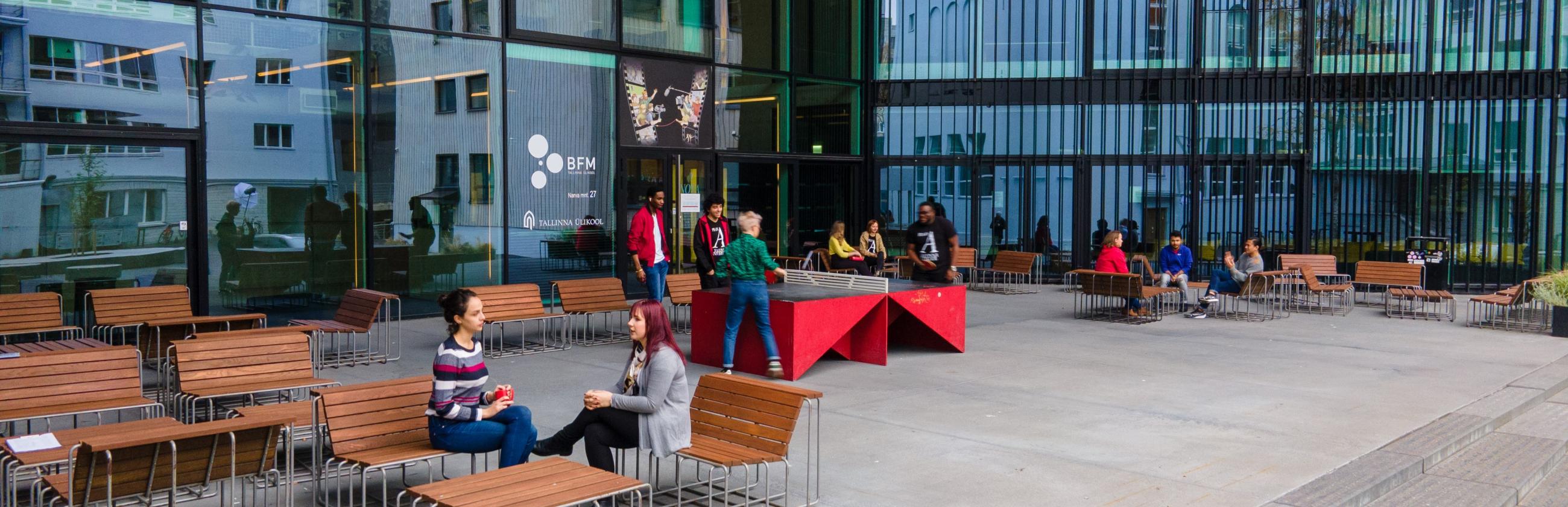 Students playing table tennis in front of the Nova building