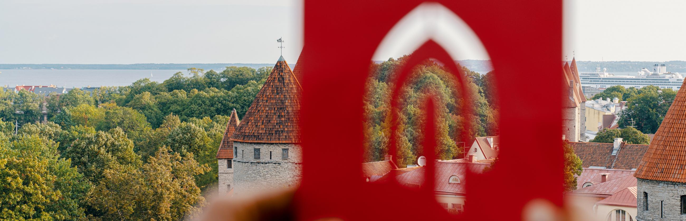 Tallinn University logo in front of the old town of Tallinn