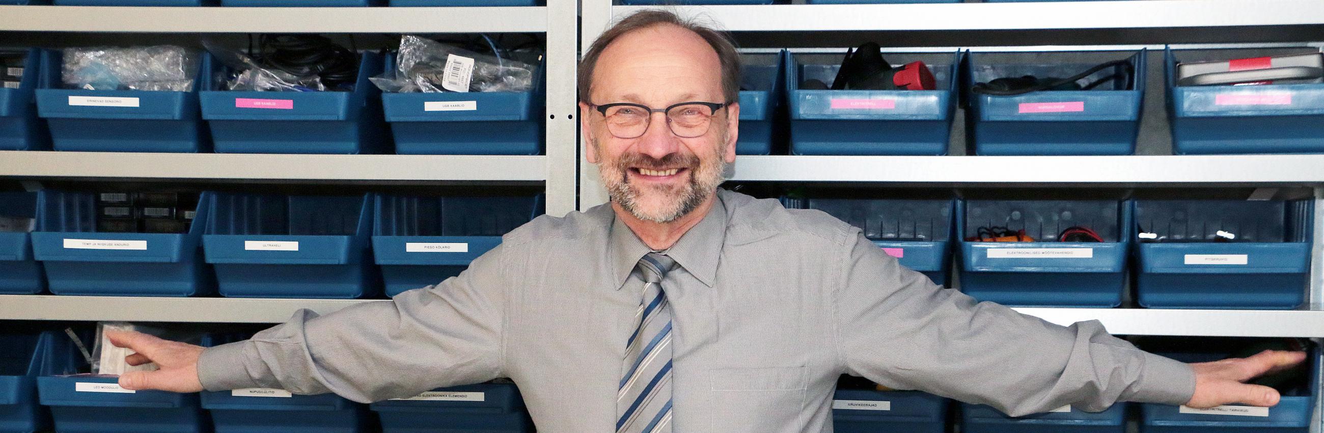 Man standing before a shelf of IoT components