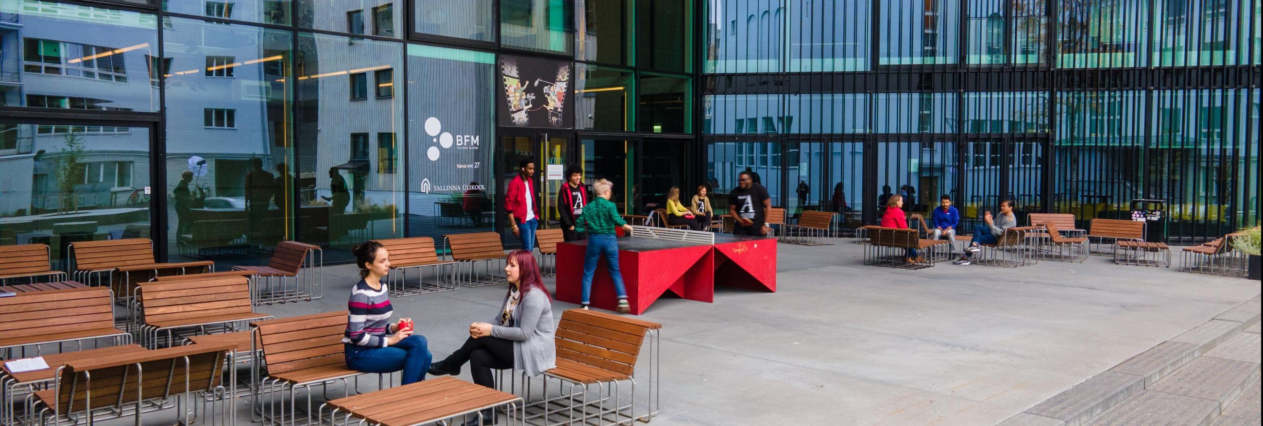 Students playing table tennis in front of the Nova building