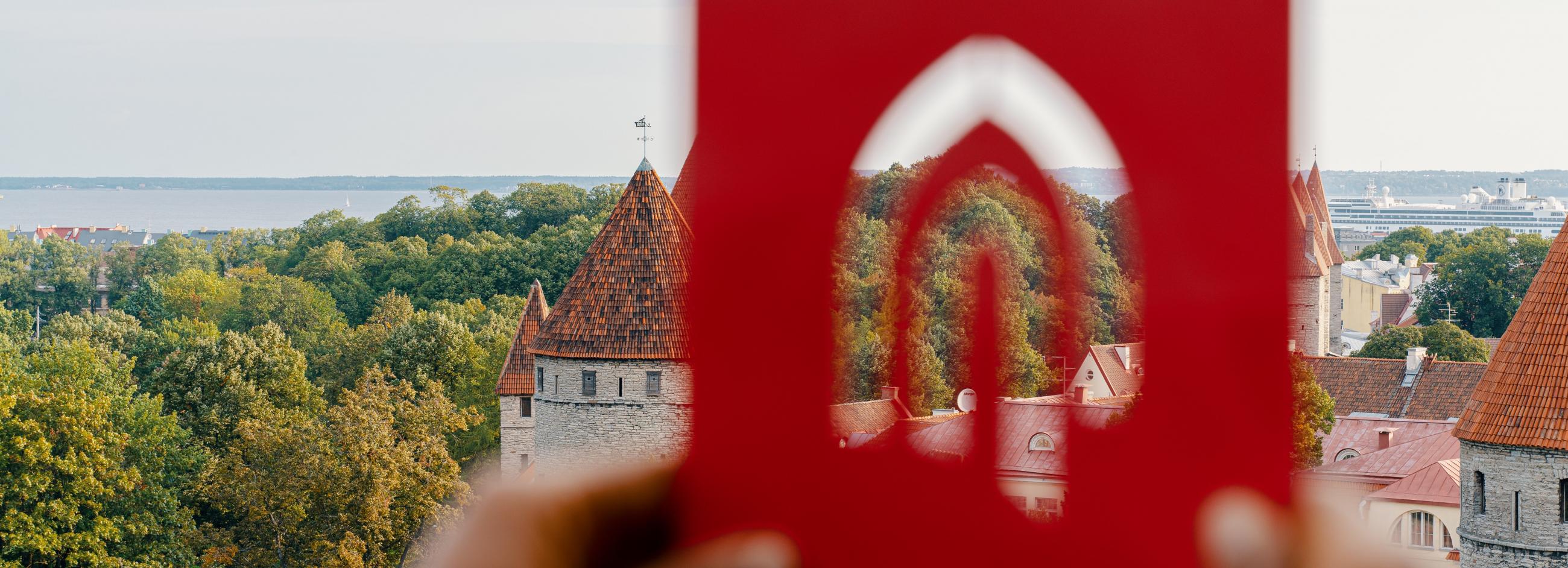 Tallinn University logo in front of the old town of Tallinn