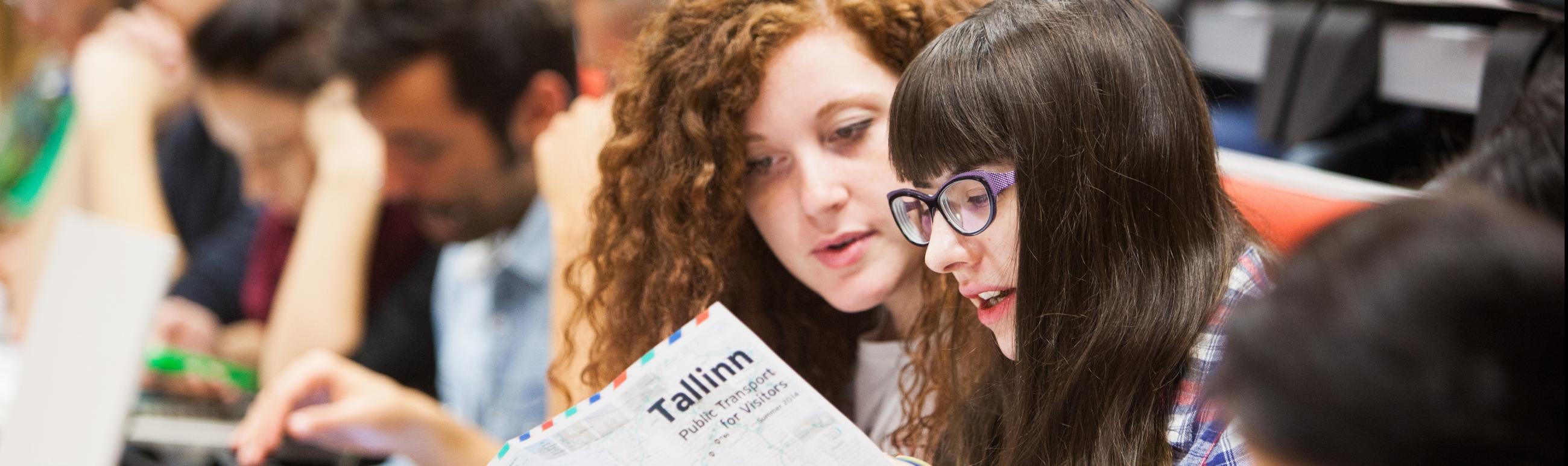 two students looking at the map