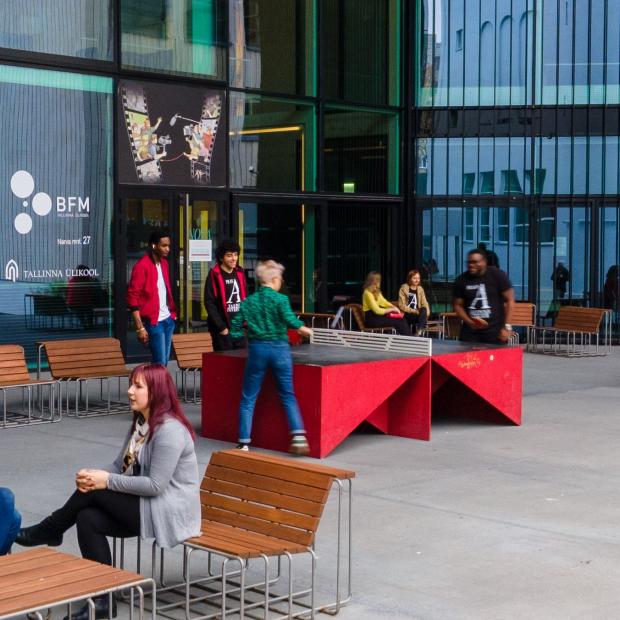 Students playing table tennis in front of the Nova building