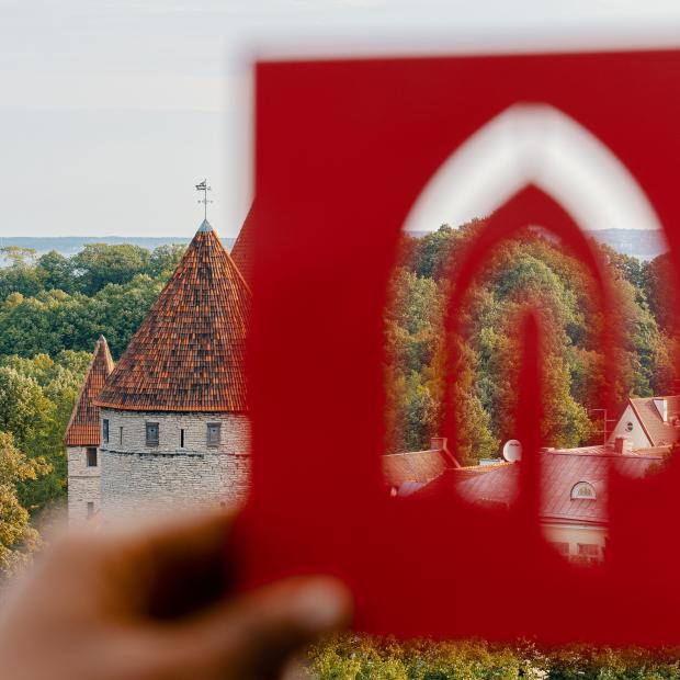 Tallinn University logo in front of the old town of Tallinn