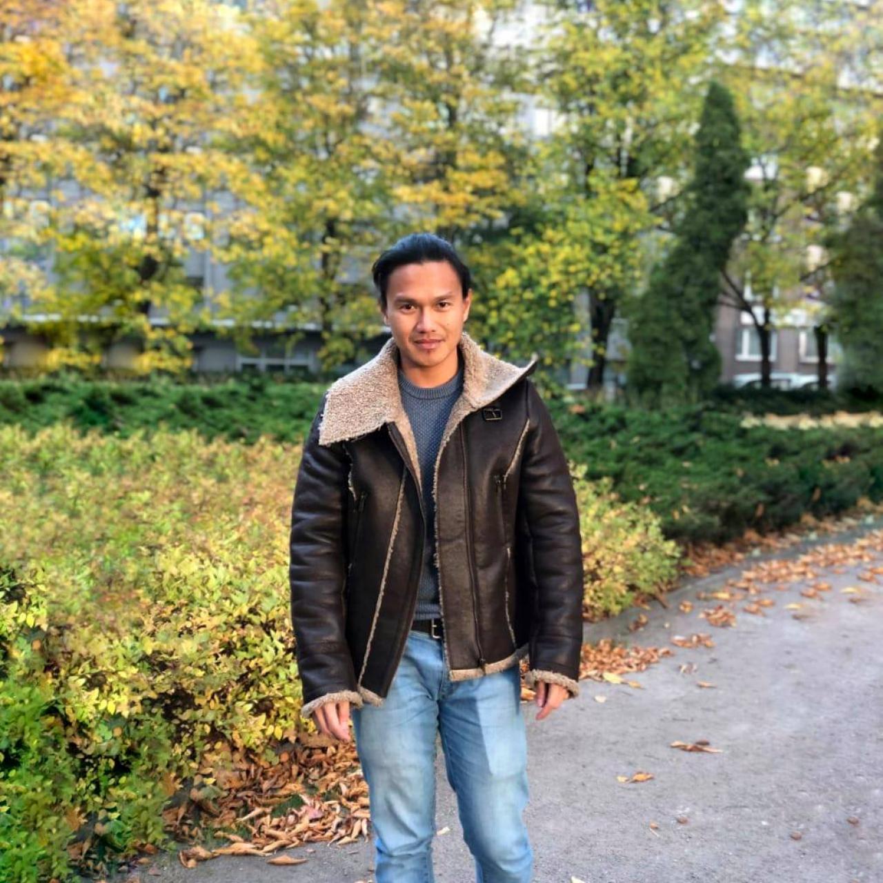 Decorative image of RJ standing in a park